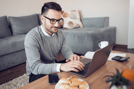 Man sat at his desk completing his tenant reference checks